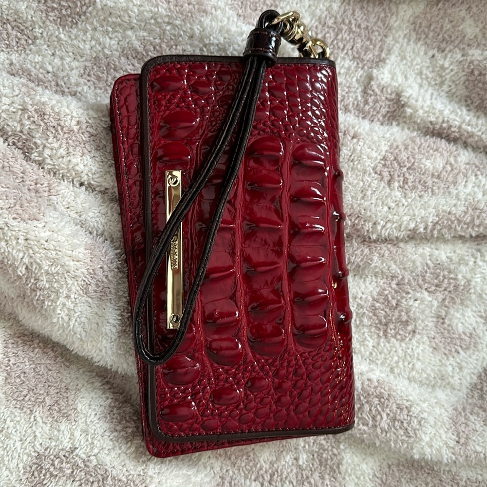 Brahmin Debra cell phone wristlet in red with chocolate trim.